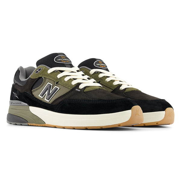 The NB NUMERIC REYNOLDS 933 in Black/Dark Olivine features white laces, gum soles, and an ABZORB in-sole for comfort, shown on a white background.