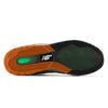 The image shows the sole of the NB NUMERIC REYNOLDS 933 BLACK / DARK OLIVINE shoe with black, green, and orange rubber tread, featuring the white NB NUMERIC logo at the center and advanced FuelCell foam for responsive cushioning.