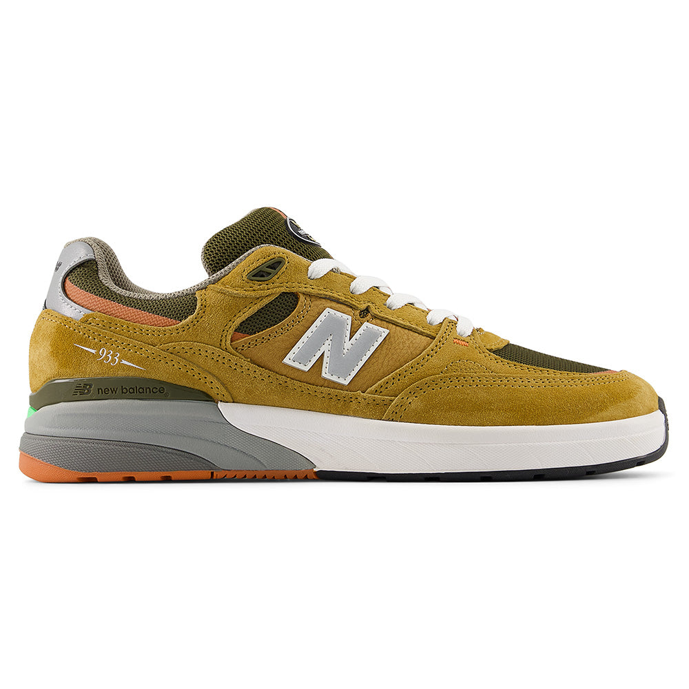 The NB NUMERIC REYNOLDS 933 CAMEL / DARK BROWN sneaker by NB NUMERIC features camel and dark brown tones, white laces, grey details, orange accents on the heel and sole, plus ABZORB midsole cushioning for all-day comfort.