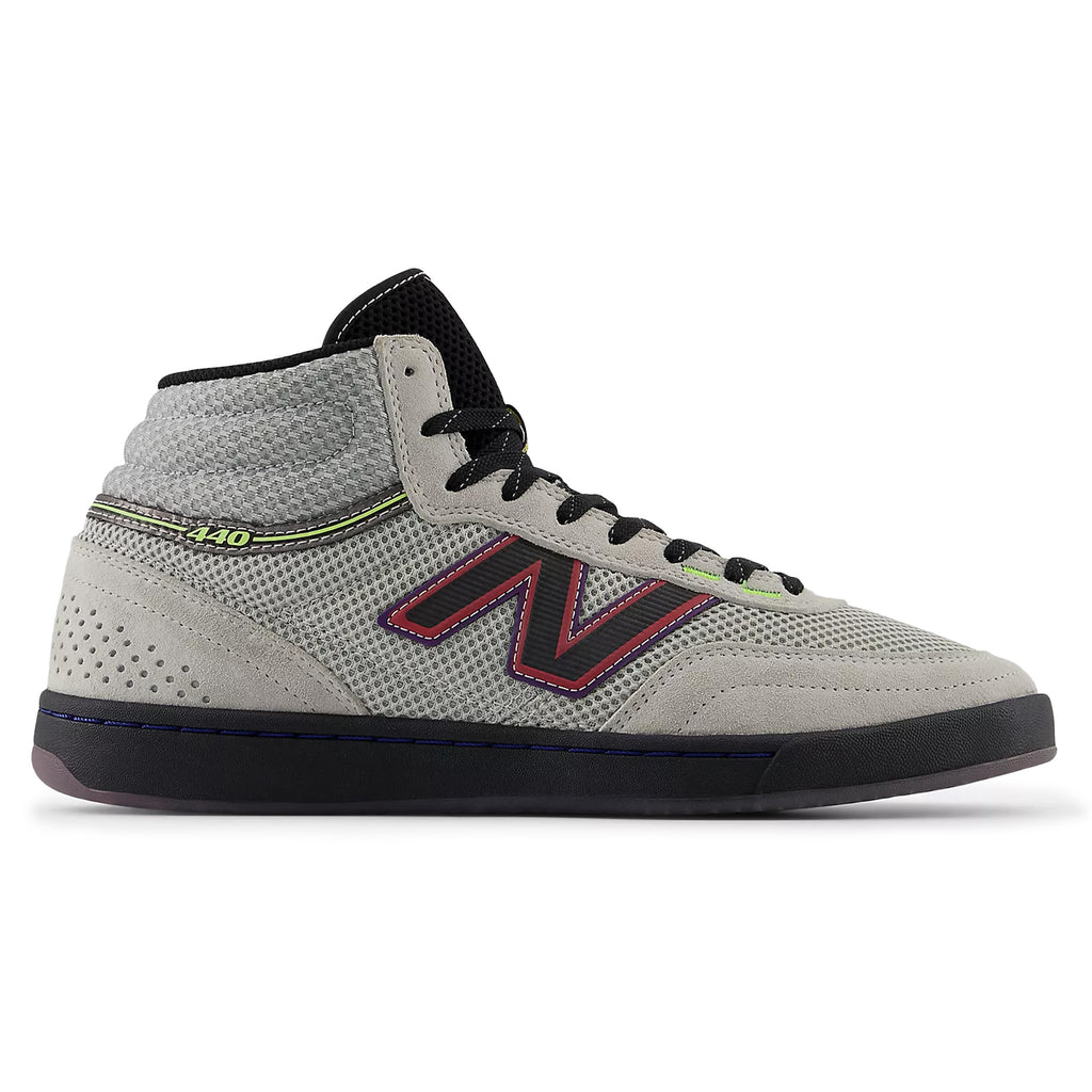 The NB Numeric x Justin Henry 440 High V2 in grey and purple is a high-top skate shoe that features a mesh texture with eye-catching red accents on the logo and sole, making it ideal for any skate team.