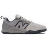 A grey NB NUMERIC X AUDAZO "GREY DAYS" athletic shoe with a black "N" logo on the side, featuring a mesh upper for breathability, Fresh Foam cushioning for enhanced comfort, a heel pull tab, and a textured sole for grip.