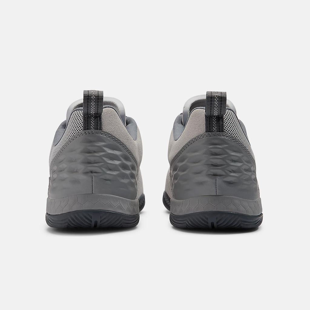Rear view of a pair of NB NUMERIC NB NUMERIC X AUDAZO "GREY DAYS" with a textured pattern on the heels, black pull tabs, and Fresh Foam cushioning for enhanced comfort.