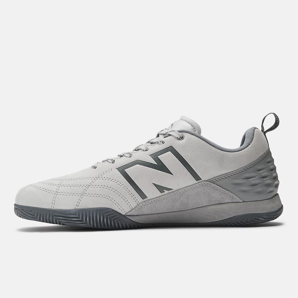 Gray athletic shoe featuring a large dark gray "N" on the side, lace-up design, and a textured sole. The NB NUMERIC NB NUMERIC X AUDAZO "GREY DAYS" hybrid futsal and skate shoe offers enhanced performance with Fresh Foam cushioning for superior comfort.