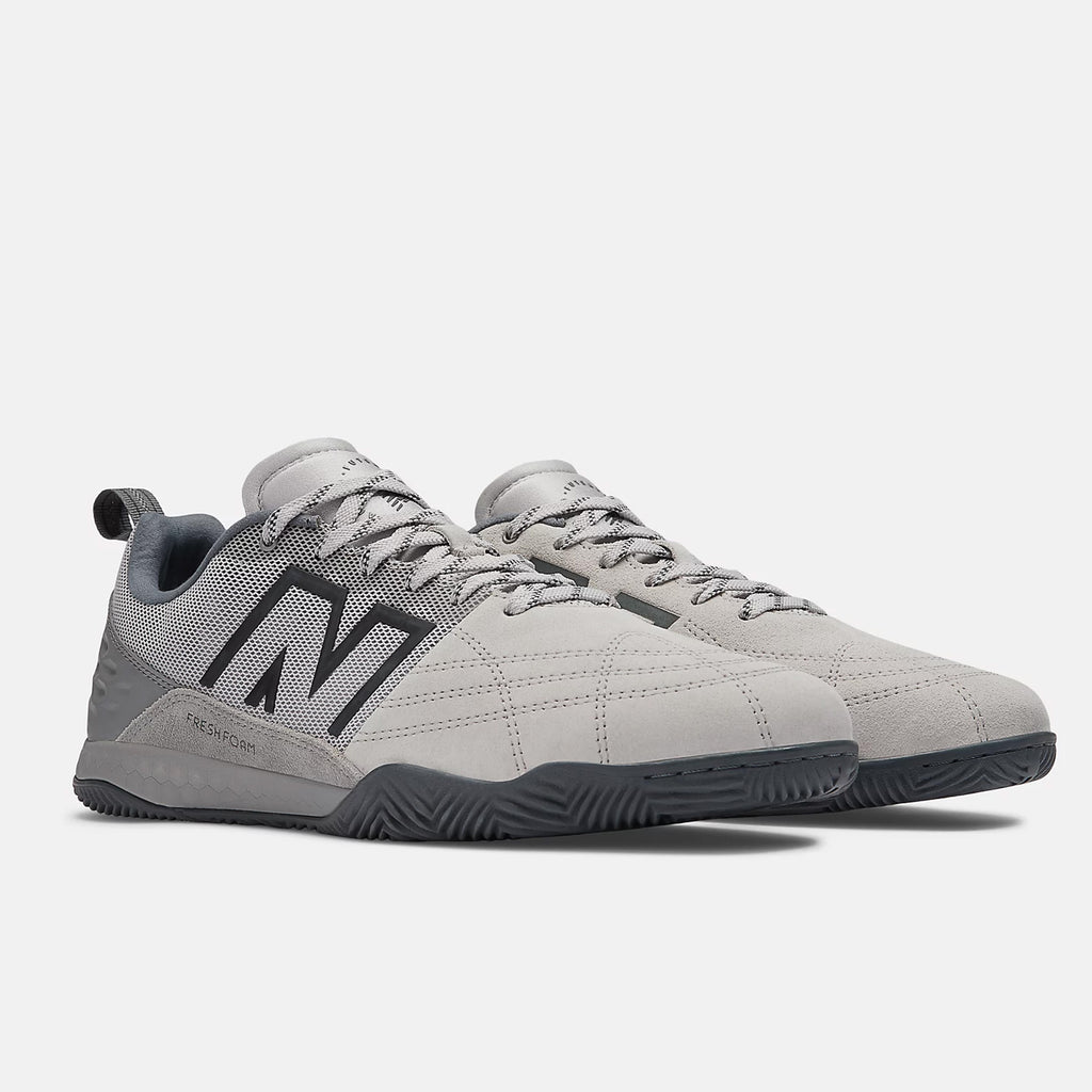 A pair of grey NB NUMERIC sneakers with black detailing and laces, featuring the brand's logo on the side and Fresh Foam cushioning for ultimate comfort, displayed on a white background.