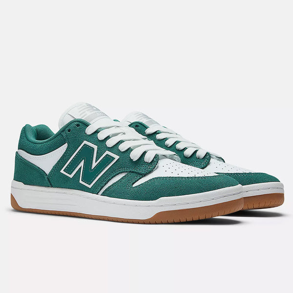 NB NUMERIC's 480 VINTAGE TEAL/WHITE sneakers blend green and white hues with a gum sole and the iconic "N" on the sides, offering stylish appeal. Crafted with ABZORB in-sole technology, they ensure superior comfort at every step.