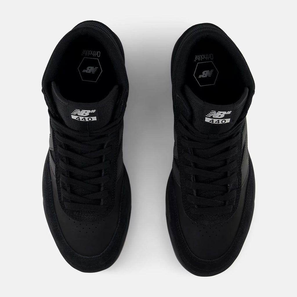 A pair of black NB Numeric 440 High V2 skate shoes is shown from a top view, prominently showcasing the NB Numeric label on the tongues against a clean white background.