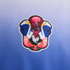 Embroidered patch featuring a stylized design of two vultures facing each other with a blood-red central figure on a gradient blue background, inspired by global motifs and crafted to perfectly complement your favorite NIKE SB 2024 FEDERATION KIT LONG SLEEVE SKATE TEE USA WHITE by Nike.