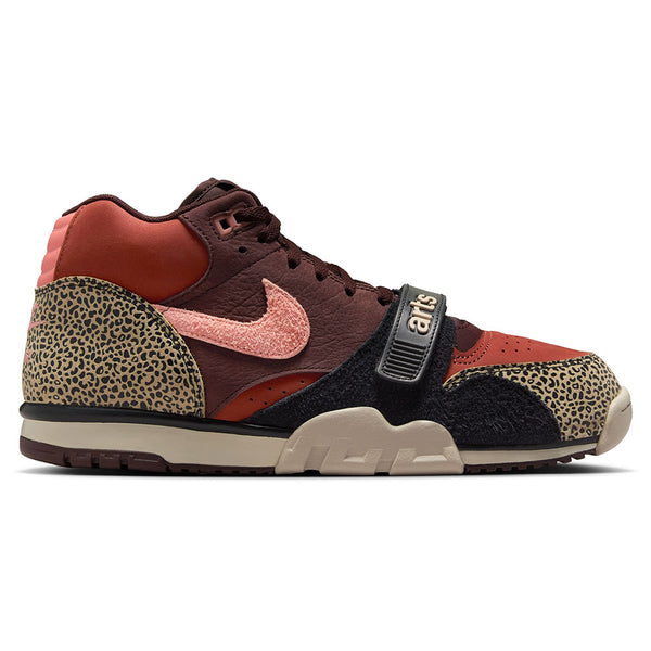 The NIKE SB x Arts-Rec Air Trainer 1 Limestone/Pink Quartz-Earth-Dusty Peach-Black-Desert Sand features maroon, pink, and animal print accents—perfect skateboarding shoes for fans of bold styles.