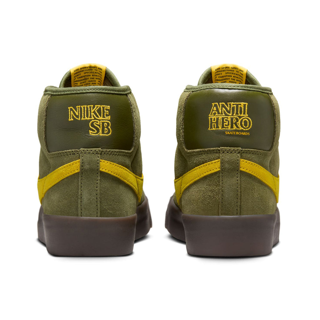 Back view of Rough Green and Amarillo Nike SB x Antihero Blazer GT Mid shoes featuring "Nike SB" and "Anti Hero" branding on the heels, ideal for skateboarding.