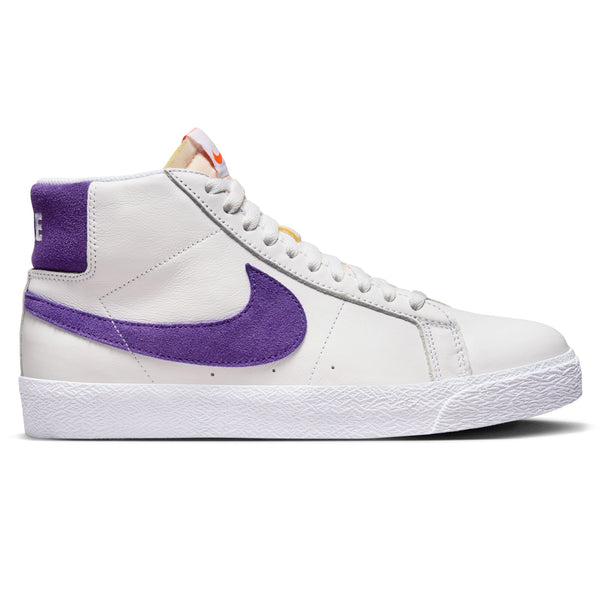 A white leather shoe with purple suede accents on the back and on the nike swoosh.