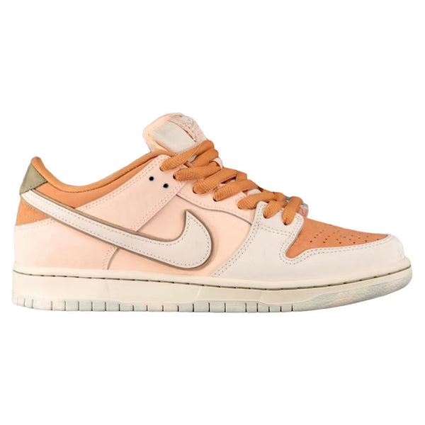 A beige and orange nike NIKE SB DUNK LOW PRO PRM AMBER BROWN / GUAVA ICE sneaker with white accents, a distinctive Swoosh logo, and a white sole, capturing the essence of Burnt Sunrise.