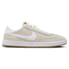 The side view of the NIKE SB FC CLASSIC SUMMIT WHITE / SUMMIT WHITE sneaker showcases a beige and white design featuring Nike's iconic swoosh logo in white, an olive khaki accent, and a light brown sole, making it ideal for skateboarding enthusiasts.