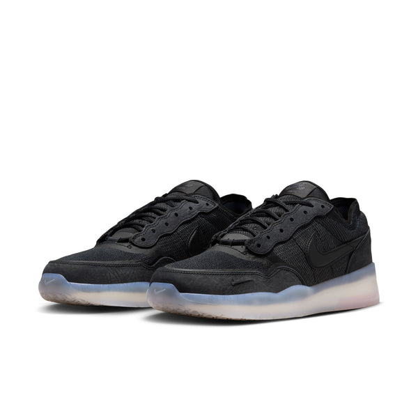 A pair of NIKE SB PS8 sneakers in black with a semi-translucent sole and Flyknit construction, shown against a plain white background.