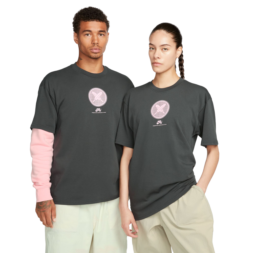 Two people wearing a faded black tshirt with a pink circle logo on it.