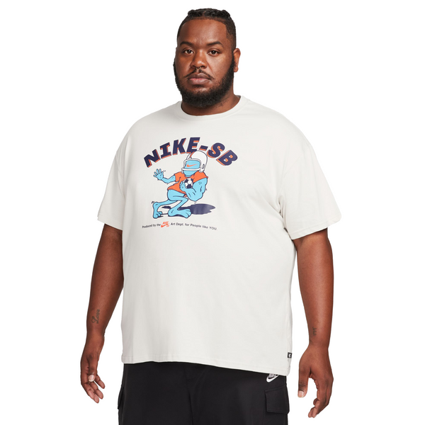 The man is wearing a nike SB 'Sports Guy' skate tee light bone.