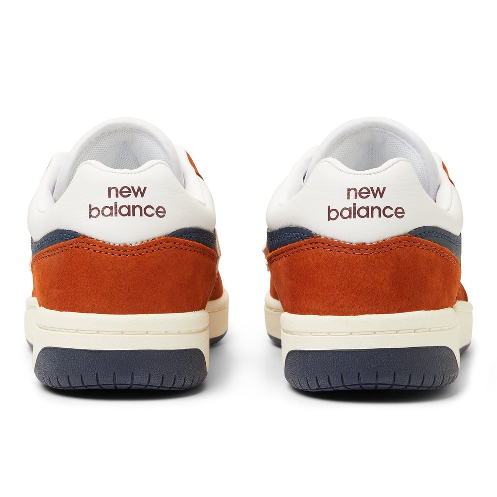 A pair of NB NUMERIC 480 BROWN / WHITE sneakers in orange and blue.