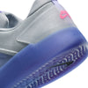Close-up of a NIKE SB NYJAH 4 in LT THISTLE/BLACK-LT THISTLE-WOLF GREY-HYPER PINK, featuring a gray mesh upper, lightweight durability, purple translucent sole, pink heel Nike logo, and wavy tread pattern.