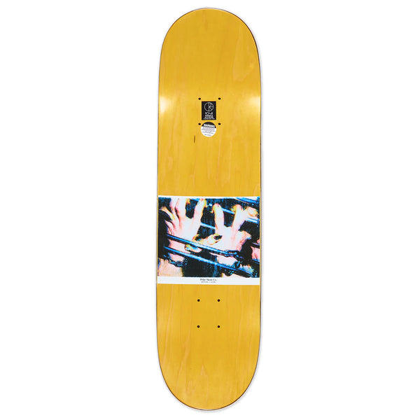 A yellow top stained skateboard with an image of hands chained up holding onto bars.