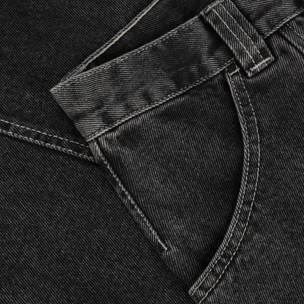 Close-up view of the waistband and pocket of dark gray POLAR JIRO PANTS SILVER BLACK denim jeans with visible stitching, showcasing their Silver Black hue. Made from 100% cotton, these jeans offer both comfort and style.