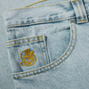 A close up of a POLAR '93! DENIM LIGHT BLUE pocket with a gold emblem on it, made from denim fabric.