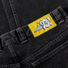 A pair of POLAR '93! DENIM SILVER BLACK jeans with a yellow POLAR label on them.
