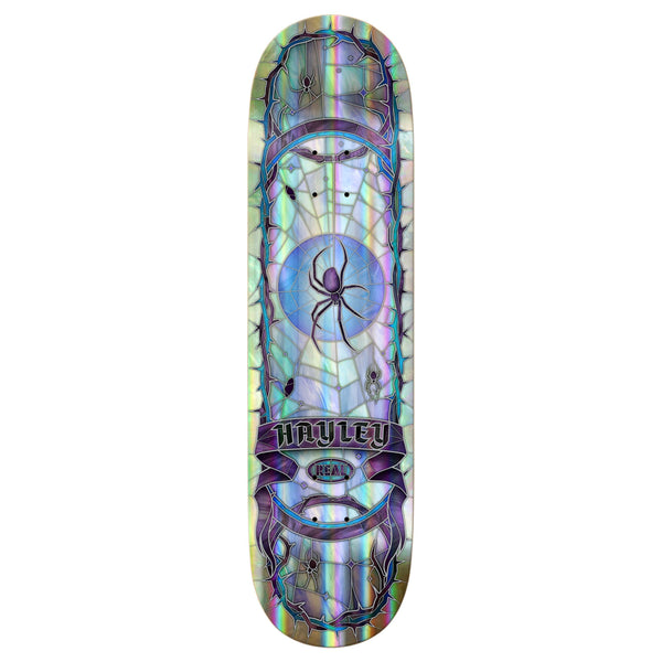 The REAL HAYLEY CATHEDRAL RAINBOW HOLOGRAPHIC skateboard deck by REAL features a bold spider and web design, rainbow holographic colors, and showcases Hayley Cathedral's striking style.