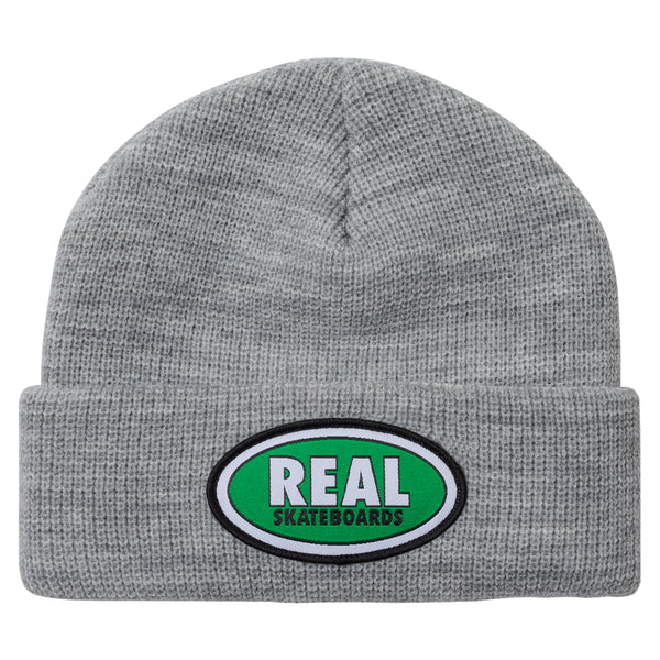 An REAL OVAL CUFF BEANIE HEATHER/GREEN with the word real on it.