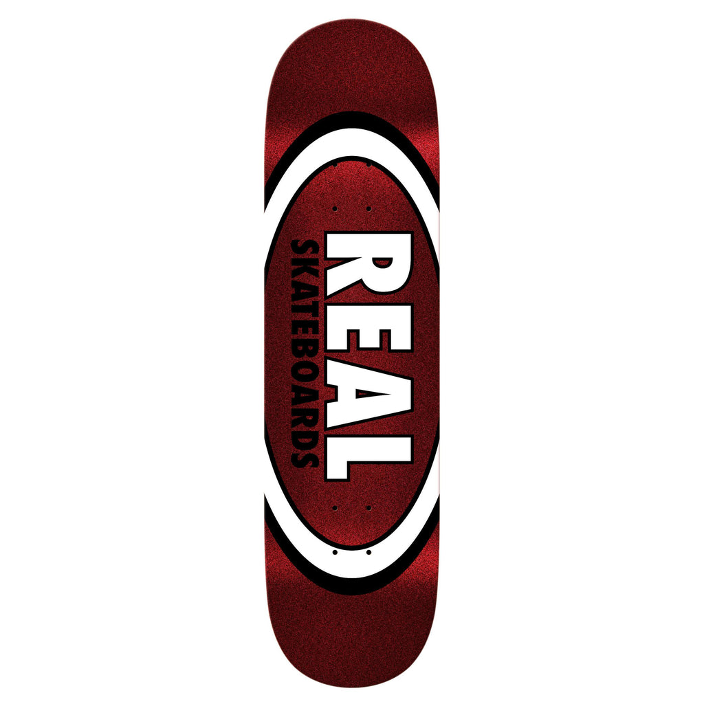 The REAL OVAL EASY RIDER RED FIRE skateboard deck by REAL features a relaxed concave for an easy riding experience, and is designed with a striking white and black oval pattern that prominently displays "REAL SKATEBOARDS" at the center.