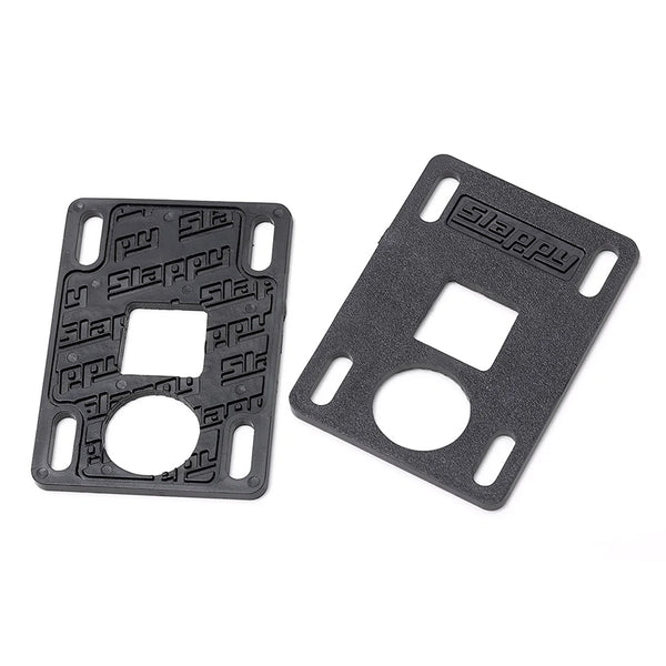 Two black rectangular plastic SLAPPY SLABS 3MM LOW RISERS by SLAPPY TRUCKS, featuring various cutouts and embossed with "Steppy" on the surface.