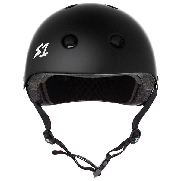 The S1 MEGA LIFER GLOSS WHITE HELMET by S1 HELMET CO. is a multi-impact skate helmet with ventilation holes, foam padding, side straps, and a buckle chin strap. Features a gloss white finish and the "S1" logo on the side.