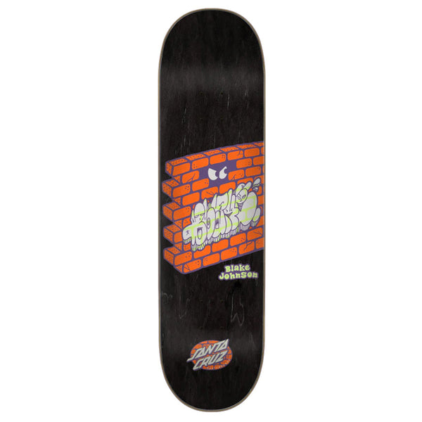 A Santa Cruz skateboard with the Johnson Other Side graffiti on it.