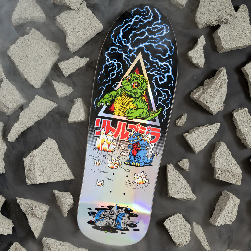 The SANTA CRUZ X GODZILLA JR. NATAS skateboard deck features an animated dinosaur and robot engaged in a triangle of lightning bolts, with fragments of shattered concrete scattered against a dark backdrop. Made from durable North American Maple, it's an ideal choice for any fan of Godzilla Destroyer.