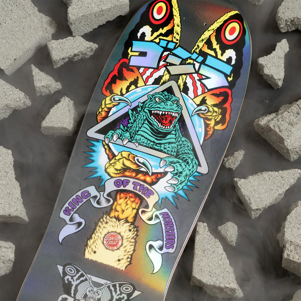 This vibrant skateboard deck, known as the SANTA CRUZ X GODZILLA MOTHRA NATAS, showcases a Godzilla-themed design featuring "King of the Monsters" text amidst broken concrete pieces. Echoing the Keith Meek OG Slasher style, it offers old school concave and is expertly crafted by SANTA CRUZ.