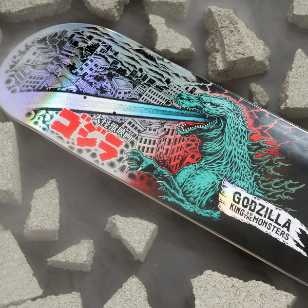 The SANTA CRUZ X GODZILLA O'BRIAN REAPER skateboard deck features a stunning depiction of Godzilla amid collapsing buildings, breathing fire. The dramatic scene is accentuated by scattered concrete and the text "Godzilla King of the Monsters." It's an essential piece from SANTA CRUZ for fans of the iconic Mecha Hand saga.