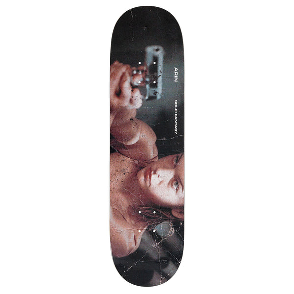 The SCI-FI FANTASY ARIN EVIL skateboard deck by SCI-FI FANTASY features a graphic of a woman pointing a gun and shows scratches and cracks—a bold tribute to the ARIN EVIL universe.