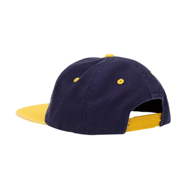A navy blue hat with a yellow brim and accessories, including a snapback.