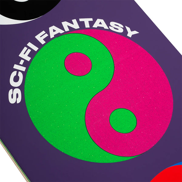 The SCI-FI FANTASY YIN YANG skateboard deck by SCI-FI FANTASY showcases a neon green and pink yin yang design with “SCI-FI FANTASY” text on a bold purple background.