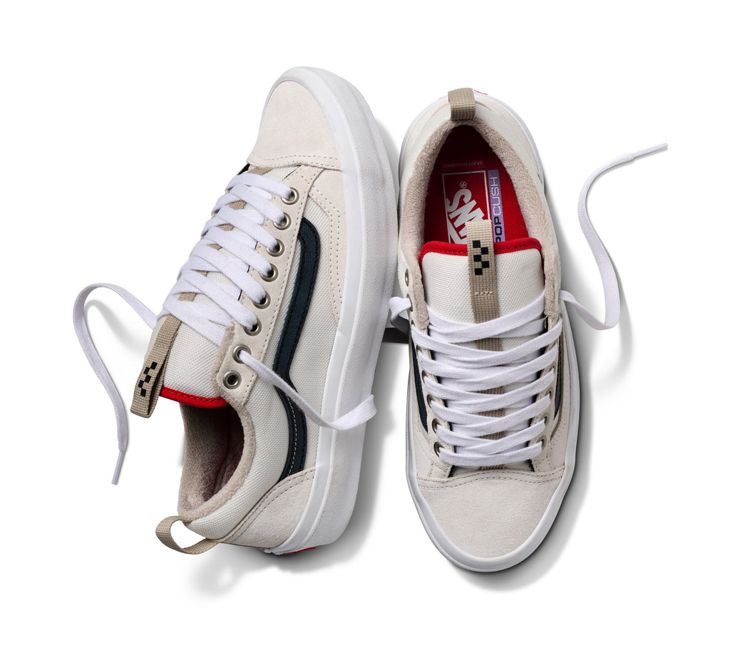 Two VANS SKATE OLD SKOOL 36+ sneakers in antique white with black stripes, red accents, and white laces featuring DURACAP technology are set against a pure white backdrop.