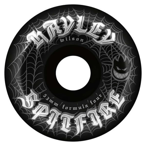 The SPITFIRE HAYLEY WEBBED CONICAL FULL 99D 53MM BLACK skateboard wheels feature white spiderweb graphics, “Hayley Wilson Spitfire” text, the Spitfire logo, and “53mm 99D formula four” on the edge.