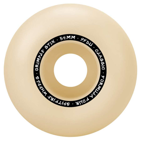 A beige skateboard wheel with black text around the central hole reads, "SPITFIRE, SPITFIRE X GRIMPLE STIX F4 CLASSICS 99D 54MM.