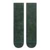 The STANCE SOCKS ICON DYED PINE LARGE by STANCE are dark green crew socks in a soft cotton blend, featuring a ribbed upper section and a blue-striped design with text near the toes, shown side by side on a white background.