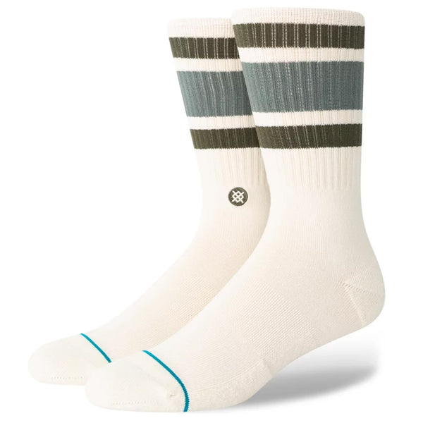 A pair of ivory socks with olive and teal stripes towards the calf.