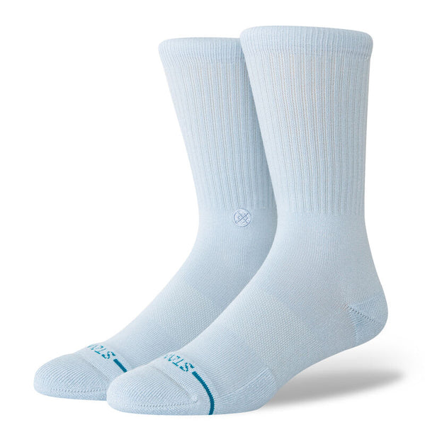 A pair of light blue crew socks with ribbed cuffs and printed branding on the toes, showcasing STANCE's iconic style in a fresh ICON ICE BLUE color.