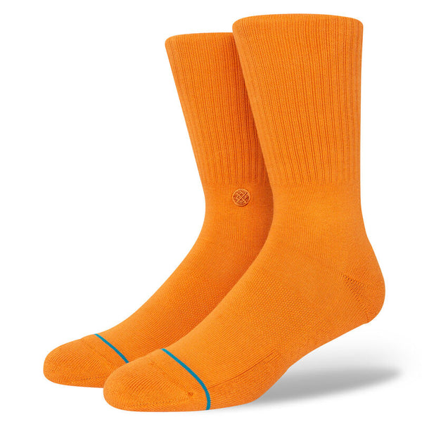A pair of STANCE SOCKS ICON RUST LARGE in orange on a white background.