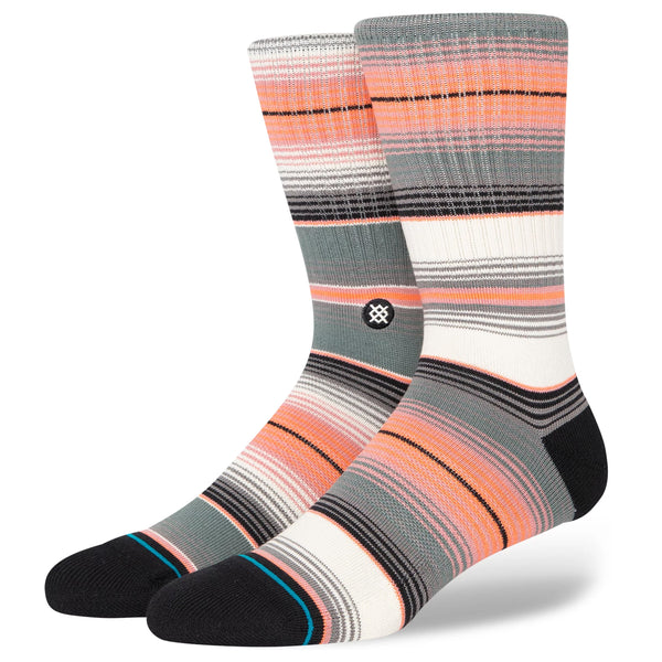 A pair of bright orange, pink, grey, black, and white striped socks.