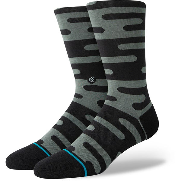 A pair of black and grey/green patterned socks.