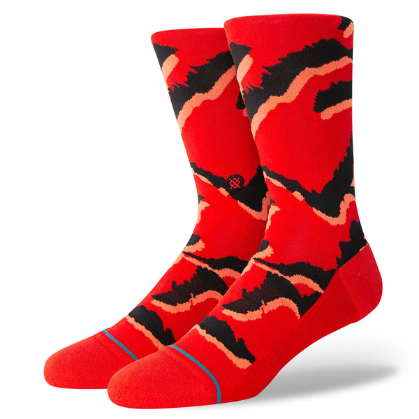 A pair of red socks with a salmon and black designed print.