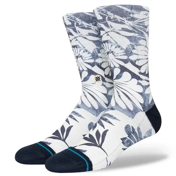 A pair of STANCE socks with blue and white flowers on them.