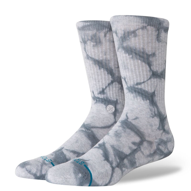 The STANCE ICON DYE CREW socks in gray, with ribbed cuffs and medium cushioning, stand upright.