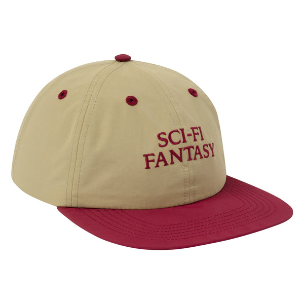 A khaki colored hat with a dark red bill and dark red details, including the logo on across the front.